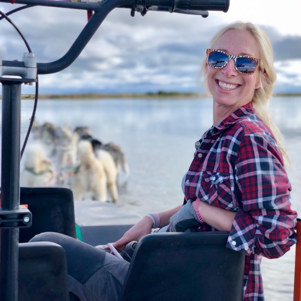 klara owner posing on dog kart dog sledding kart tour on glacier river